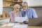 Upset Elderly Couple Checking Financial Documents While Calculating Family Budget At Home