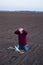 Upset farmer beside fallen drone in field