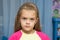 Upset five year old girl with tearful eyes