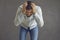 Upset frustrated man holding his head in despair standing against grey studio background