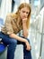 Upset girl in headphones sitting in a subway car