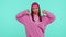 Upset girl in pink hoodie showing thumbs down sign gesture, disapproval, dissatisfied, dislike