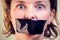 Upset girl with self-adhesive tape over her mouth. Kidnapping concept