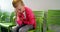 Upset girl sitting on chair in hospital corridor