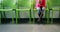 Upset girl sitting on chair in hospital corridor