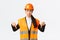 Upset and gloomy asian female construction manager in safety helmet and reflective jacket, pointing fingers down and