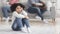 Upset little girl suffering from parents quarrels, sitting on floor alone