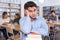 Upset man with stack of books in library