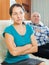 Upset mature woman against elderly husband