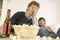 Upset Men Watching TV With Popcorn And Beer On Table