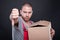 Upset mover man holding box showing thumb down