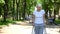 Upset old woman moving outdoors with walking frame, rehabilitation after trauma