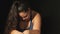 Upset overweight depressed woman on black background