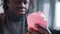 Upset poor african american black man holding empty piggy bank