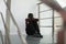 Upset preteen boy sitting on staircase