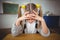 Upset pupil sitting at her desk in a classroom