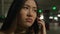 Upset sad disappointed girl Asian chinese japanese woman businesswoman in underground parking call mobile phone talk