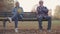 Upset senior European couple sitting on the bench separately. Mature Caucasian family quarrelled in the autumn evening