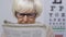 Upset senior woman in eyeglasses reading newspaper, vision problems, illness