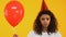 Upset teenage girl holding balloon, feeling lonely on birthday party, no friends