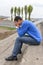 Upset teenager sitting on stairs