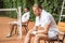 upset tennis players resting on chairs