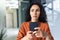 Upset thinking business woman close up inside office, young hispanic woman reading bad news on phone online, business