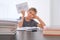 Upset tired preteen child sitting at the table, doing his homework among pile of books. Word Help is written on open