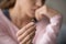 Upset woman holding wedding ring close up cropped image