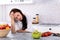 Upset Woman Leaning On Kitchen Counter