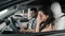 Upset woman listening male instructor during test drive lesson. Slow motion