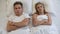 Upset young couple lying in bed, sexual problems, relations misunderstanding