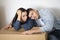 Upset Young Spouses Leaning At Cardboard Box, Having Stress While Moving Home