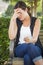 Upset Young Woman Sitting Alone on Bench