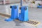 An upside down blue recycling container on a car wash. cleaning