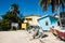 Upside Down Boats and Palm Trees in front of Caye Caulker Police