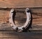 Upside down horse shoe nailed to a wood wall