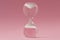 Upside-down hourglass on pink background - Concept of reverse time