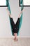 Upside down woman doing aerial yoga head stands