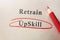 Upskill circled in red pencil below Retrain text on textured paper