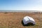 An upturned boat on the pebble beach, at Pett Level on the Sussex coast