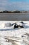 Upturned row boats have been left moored on the beach on the Suffolk coast. They have been covered in snow after a rare snow storm