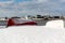 Upturned row boats have been left moored on the beach on the Suffolk coast. They have been covered in snow after a rare snow storm