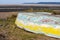 An upturned small boat washed up on the shoreline of a beautiful unspoiled beach