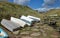 Upturned small rowing boats by a little bridge by the coast at Eype in Dorset