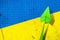 Upward arrow on the background of the flag of Ukraine. Paper plane. Economic recovery. Copy space. Business