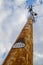 Upward Perspective of Weathered Utility Pole with Complex Wires against Dynamic Sky