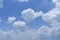 Upward photo of beautiful white fluffy clouds on vivid blue sky in a sunny day