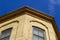 Upward view of a 19th Century yellow brick wall with cornice