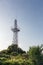 Upward view of abandoned radio communication antenna tower with plants around againt sky, Bulgaria.